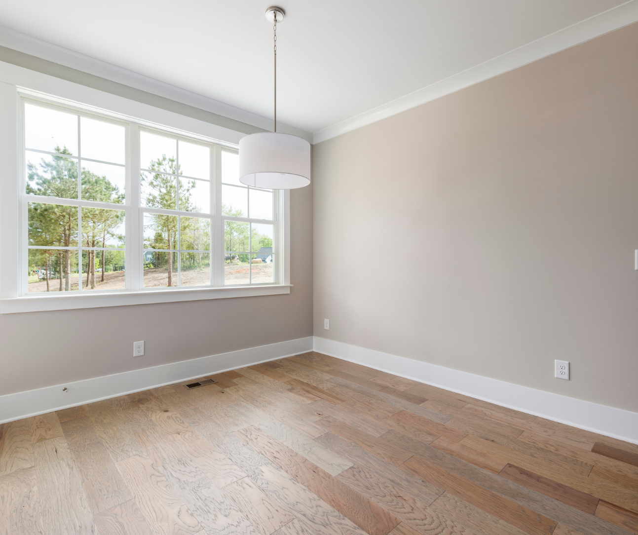 Neutral eggshell walls and LVP flooring in living room
