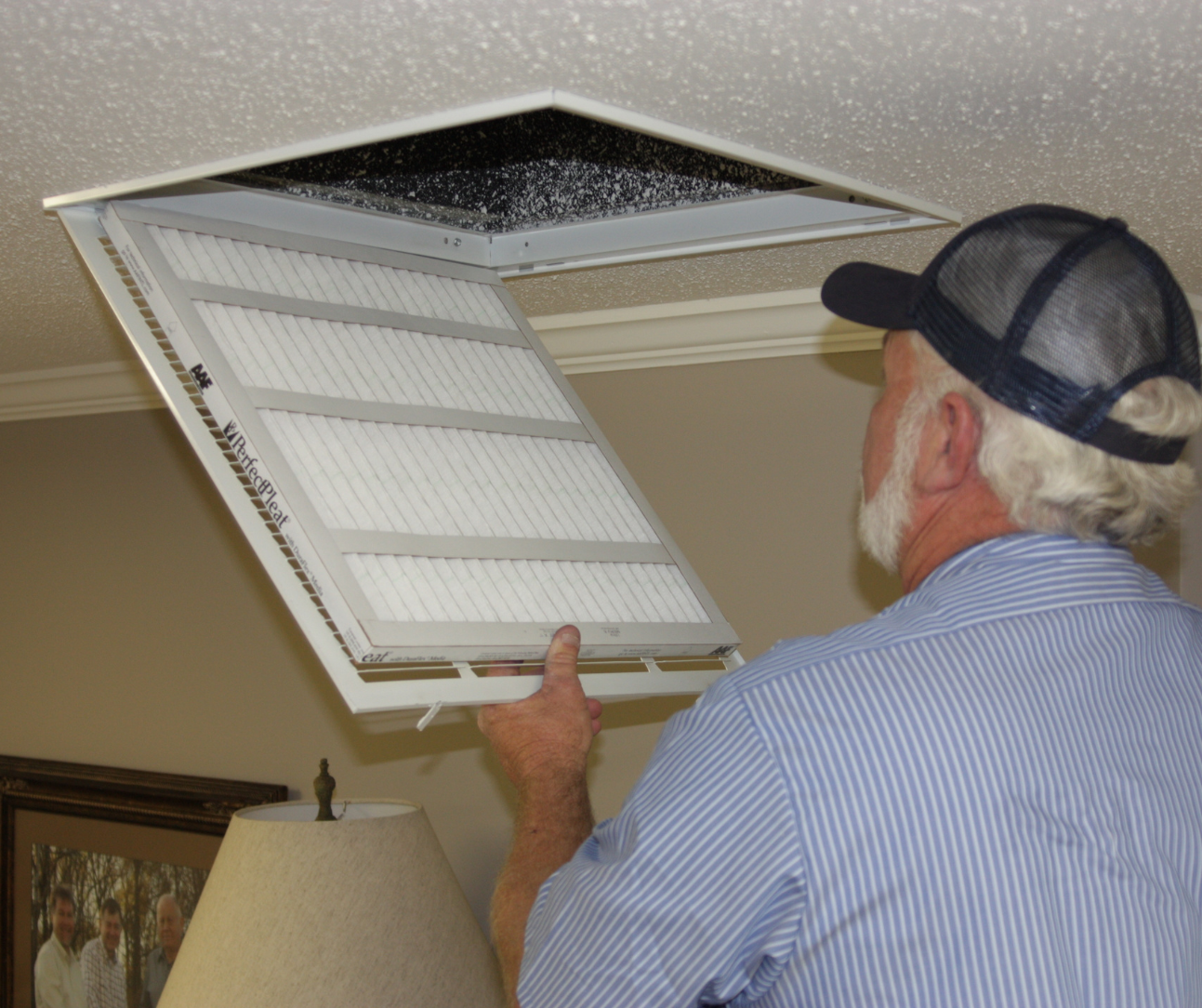 HVAC pro replacing MERV 8–11 filter before tenant move-in